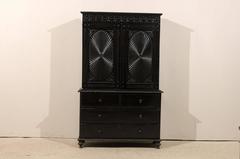 Richly Carved Shiny Black British Colonial Cabinet with Oval Pattern on Doors