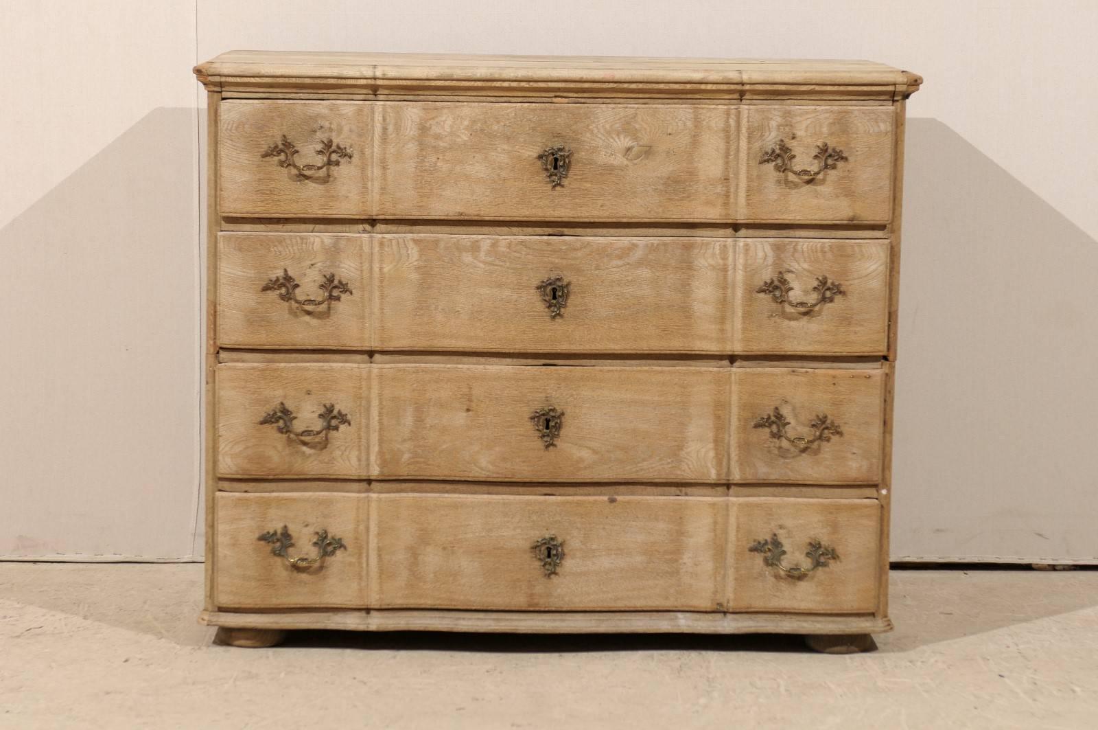 A Dutch, mid-19th century chest. This four-drawer chest with slightly serpentine front and drawers features a Rococo style hardware. This chest from circa 1850 is raised on small bun feet in the front and square in the back. It has a nice bleached