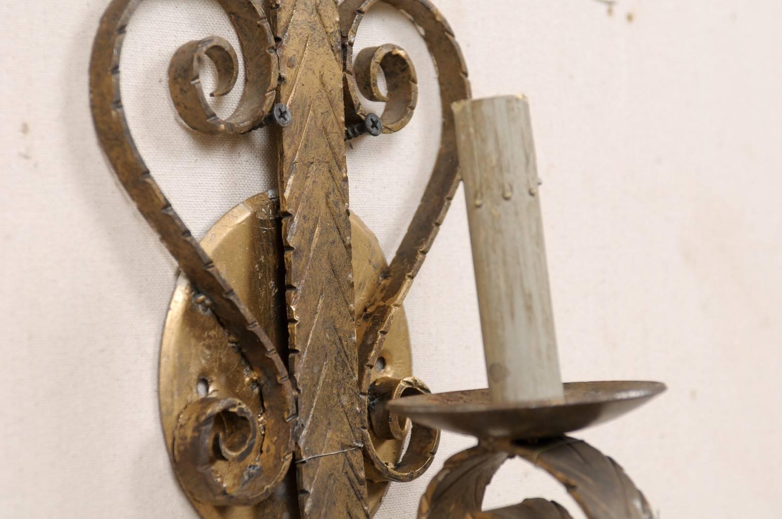 Iron Pair of Spanish Single Light Sconces Each Flanked by Scroll Motifs For Sale