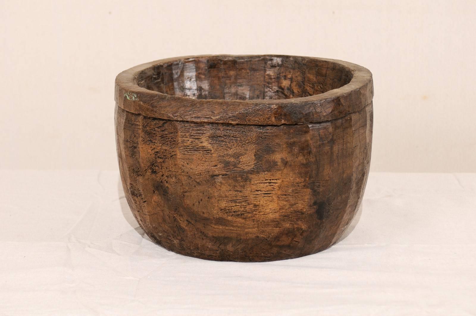A vintage Naga wood bowl. This beautifully Primitive style bowl has been carved from a single piece of wood. These bowls were originally used in kitchens of the Naga people for various food oriented activities including storing and cooking. The Naga
