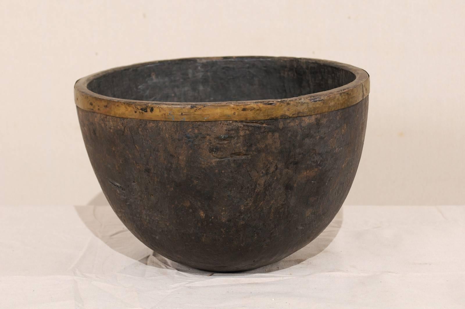 A vintage Naga wood bowl. This beautifully Primitive bowl has been carved from a single piece of wood. These bowls were originally used in kitchens of the Naga People for various food oriented activities including storing and cooking. The Naga
