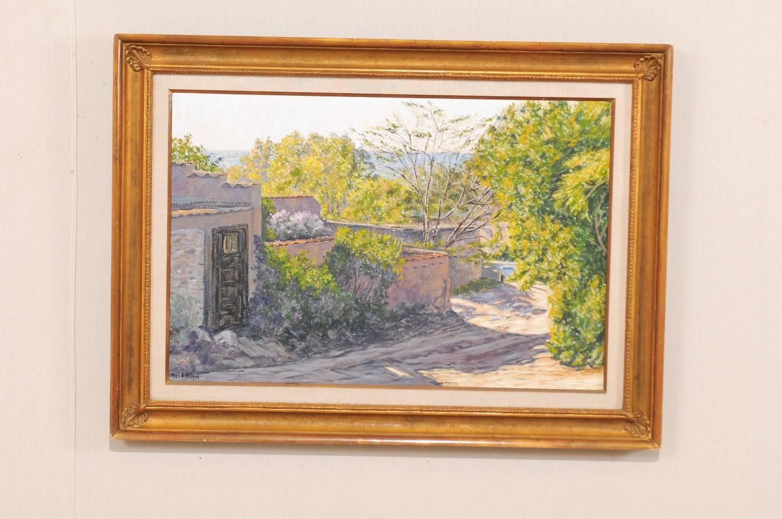 A medium sized oil painting by American artist Paul B. Wilson. This is a lovely painting depicts a Spanish Colonial style homestead and surrounding landscape in Santa Fe, New Mexico. There is a beautiful sense of light in this painting, from the