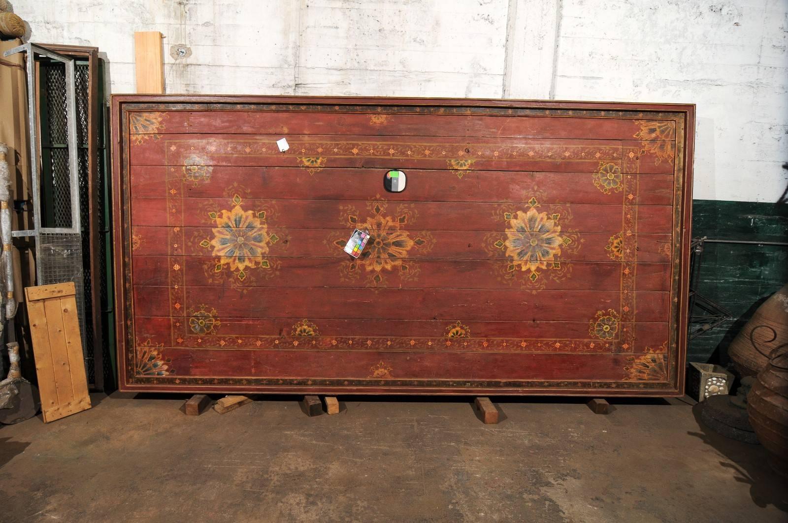 A grand sized 19th century painted wood Southern Indian decorative ceiling panel. This wooden ceiling panel from the Tamil Nadu area features a series of three mandala style paintings appropriated centered within the panel with delicate floral