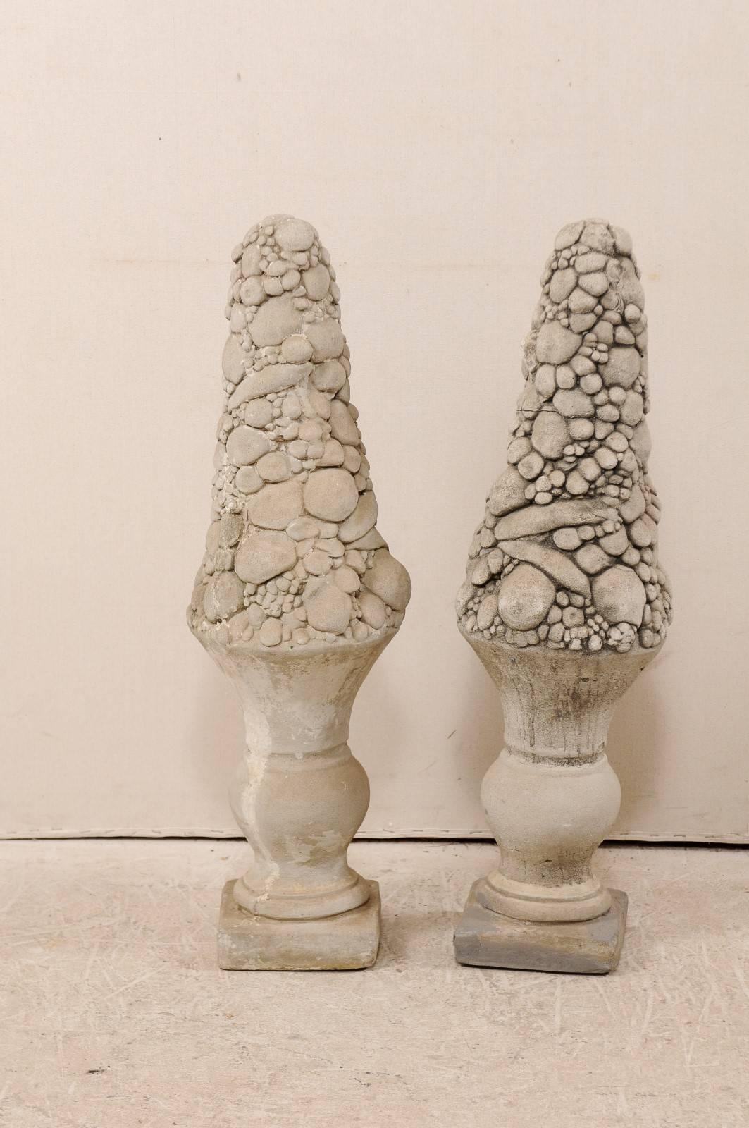 A pair of American, mid-20th century fruit topiaries. This pair of Mid-Century fruit topiaries are made from cast stone, which has been nicely weathered with age. These fruit topiaries would be a nice addition to any garden, patio or flanking a