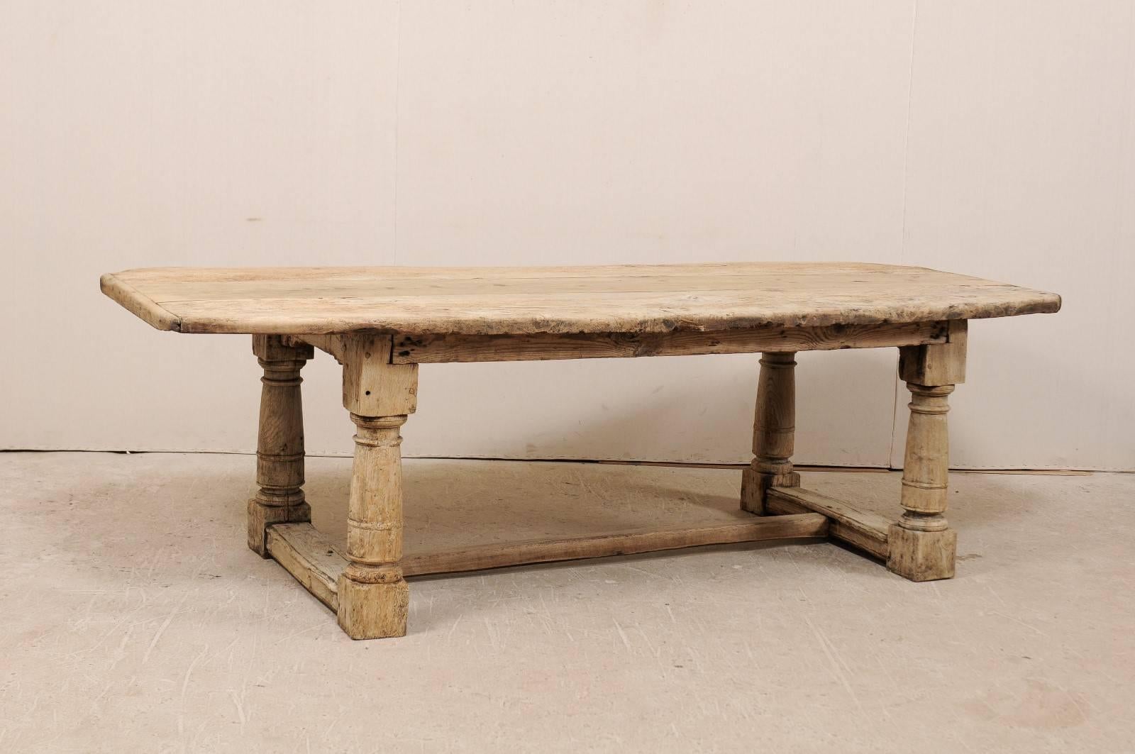 An early 18th century Italian dining table. This Italian dining table from the early 18th century (or quite possibly 17th century) is beautifully rustic with the thick slab top and stout legs. The table is bleached oak with a lovely aged wood top,
