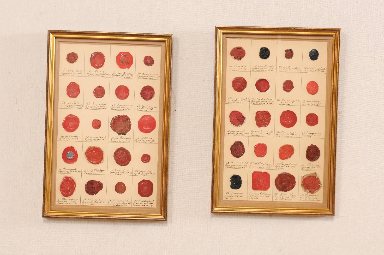 A pair of authentic early 19th century Swedish framed seals. These antique seals of Swedish nobility, have been set in custom bronze and gold toned frames. This set of seals are primarily in various shades of red, with a few black seals. Please note