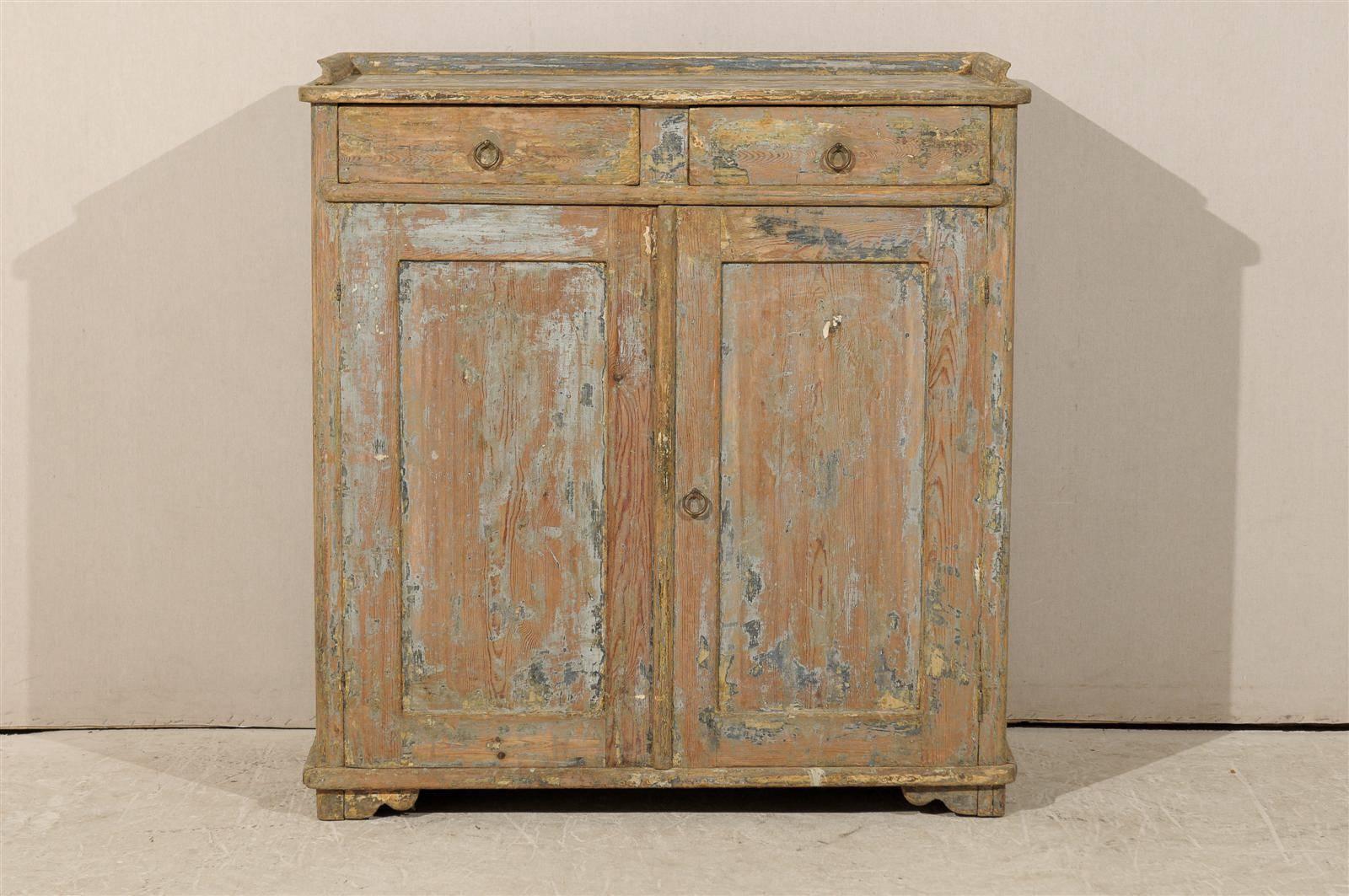 A Swedish 19th century fir wood sideboard. This sideboard features two drawers over two doors. This piece also features cute and subtle bracket feet. This Swedish piece has nice wear throughout, giving it a wonderful antique look.