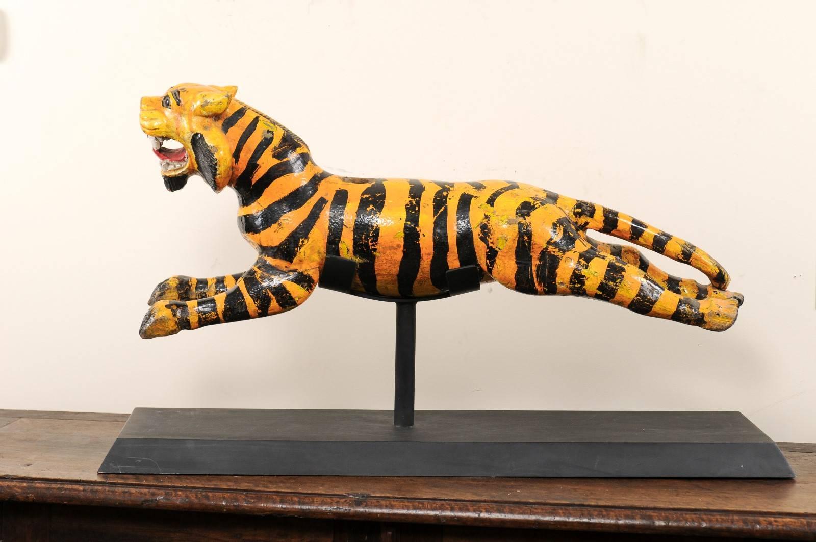 A vintage Southeast Asian carousel tiger. This whimsical tiger was originally part of a merry-go-round during the mid to later part of the 20th century. The tiger has the appearance of being in mid-run, open mouthed and bearing its teeth. It is made