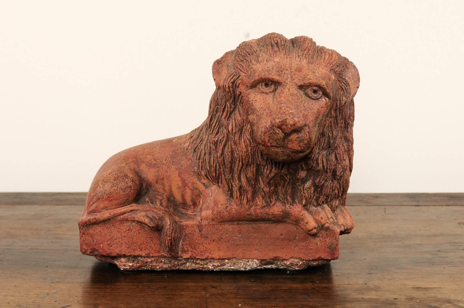 A vintage terracotta lion sculpture from Kerala, Southern India. This terracotta Kerala lion dates circa prior to 1940. This lion, with beautifully emotional eyes of interest, has an abundant mane and is in an attentive, laying position with feet