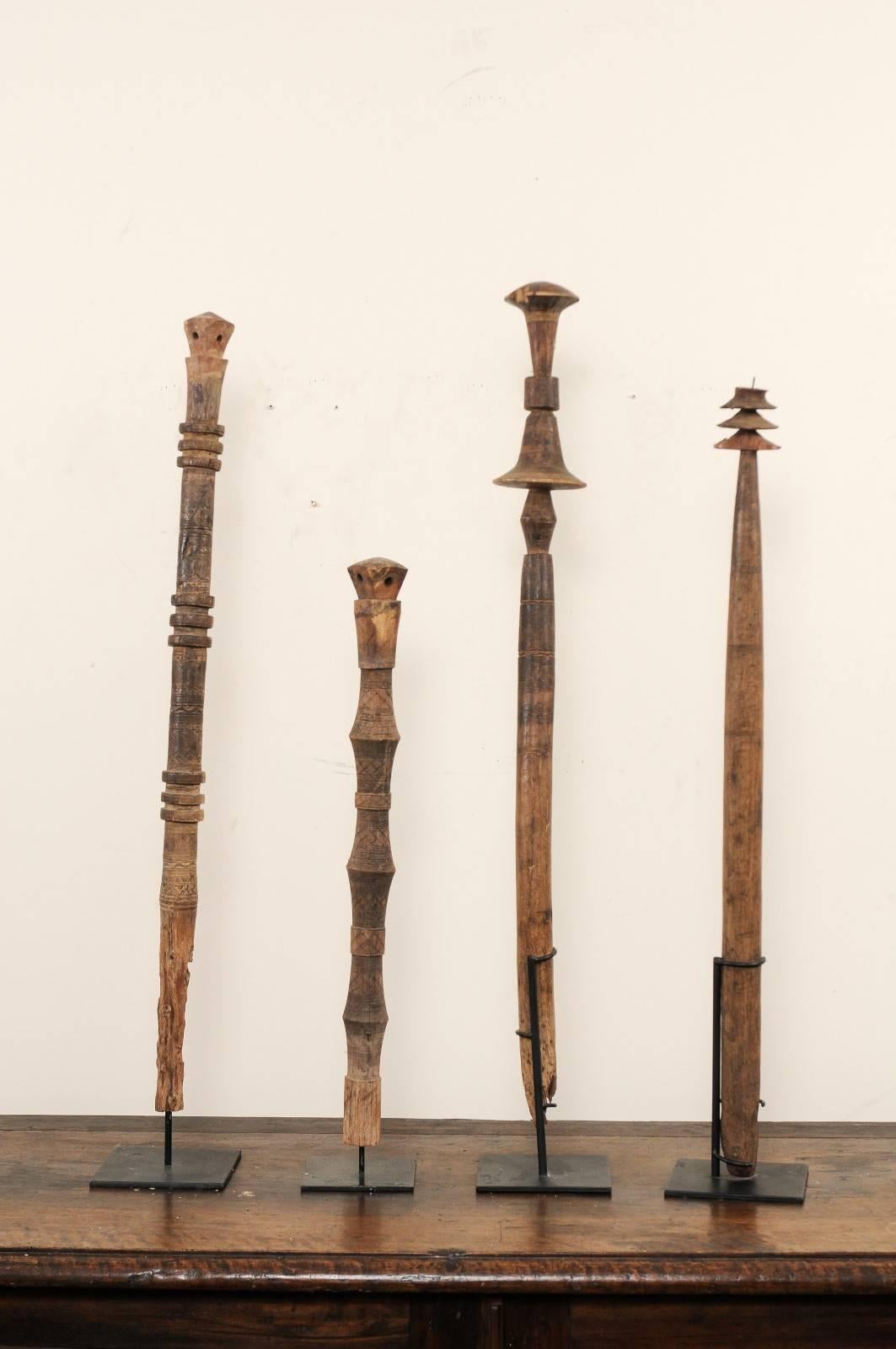A set of four Moroccan vintage carved wooden tent stakes. This collection of four Moroccan stakes, known as a 