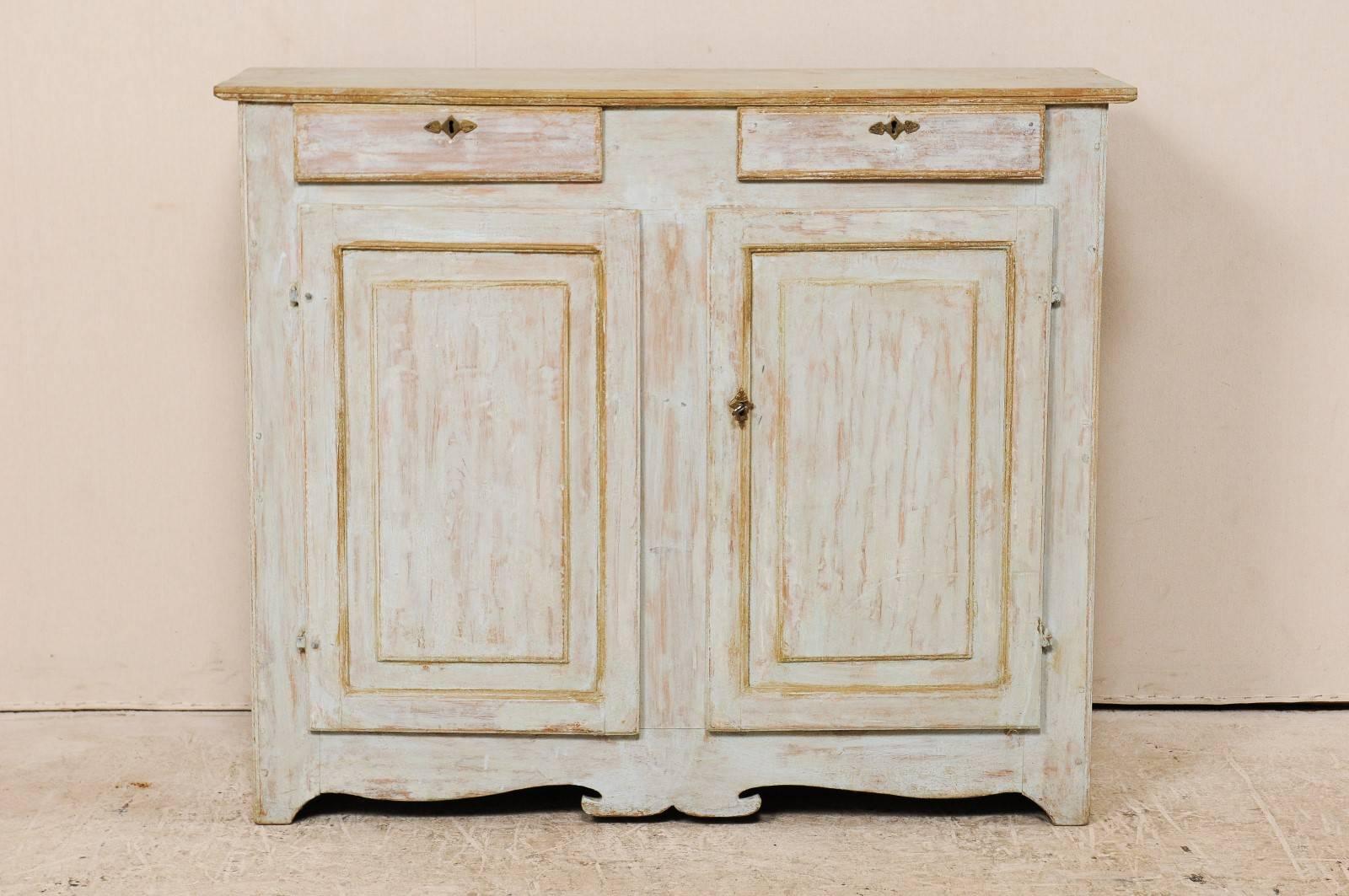 An early 19th century Swedish painted wood cabinet. This antique Karl Johan Swedish cabinet features two drawers over two paneled drawers, with interior shelves behind, and a nicely carved front skirt. The Karl Johan period follows the Gustavian