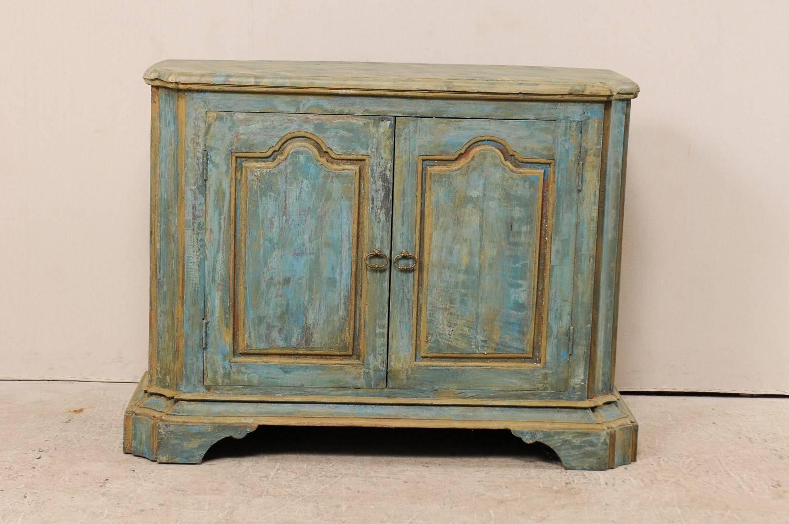 A custom American two-door painted wood buffet console. This vintage Italian style custom buffet cabinet has been made of old reclaimed doors and old wood. This cabinet features two doors, concave and canted side posts (with top buffet top carved to