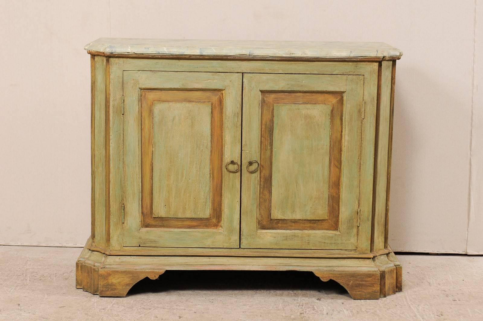 A custom American two-door painted wood buffet console. This vintage Italian style custom buffet cabinet has been fashioned of old reclaimed doors and old wood. This cabinet features a faux marbled top, two doors, concave and canted side posts (with