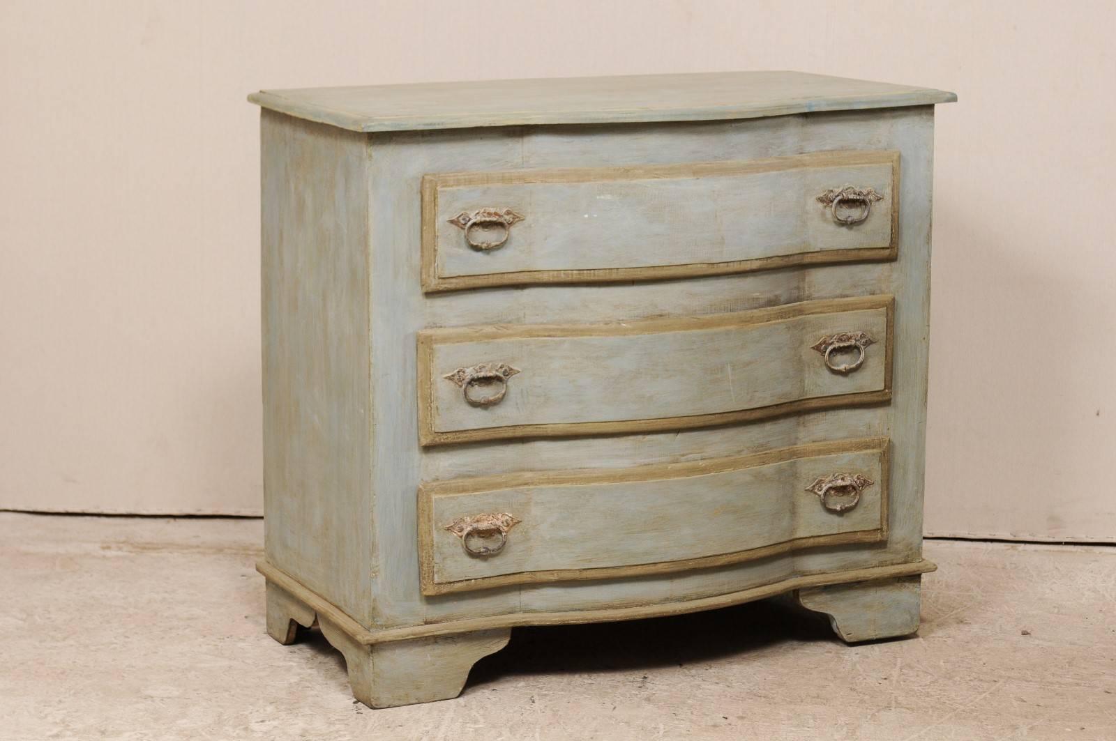 A pair of painted wood three-drawer Brazilian chests. This pair of custom dressers, of old reclaimed wood, each feature three graduated drawers with curvy shaped fronts, slightly overhung tops which have been carved to mimic the design of their