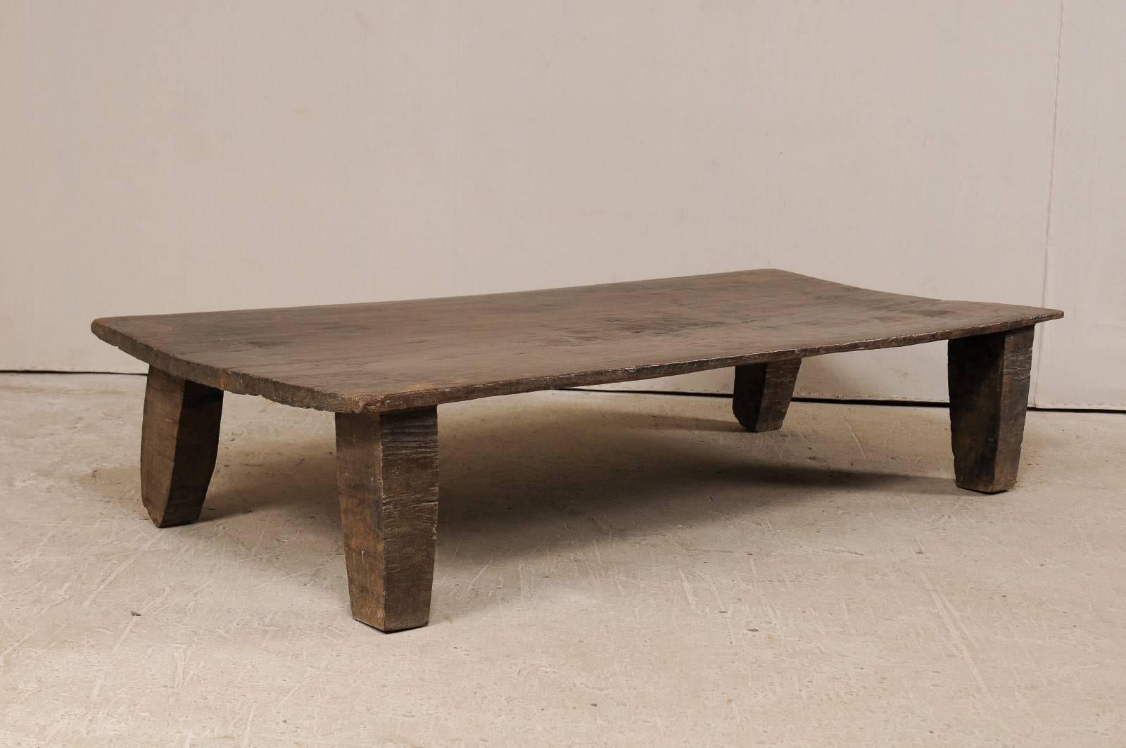 A primitive wood Naga coffee table from the early 20th century. This wooden bed from the Naga tribes of Nagaland, North East India has been carved out of a single log and would make for a great coffee table and conversational piece. Very nice rustic