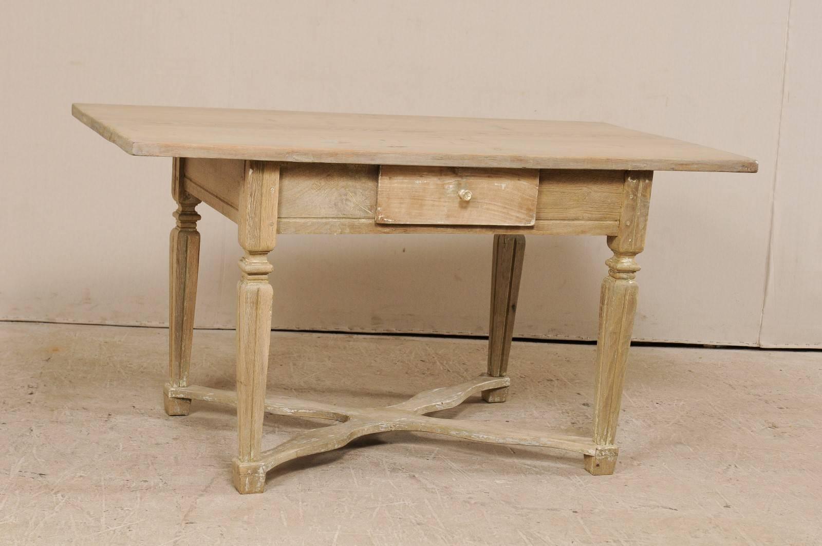 A Swedish 19th century Baroque style desk or table with single drawer. This antique Swedish desk features a rectangular-shaped top, a clean apron with single drawer, and carved fluted legs which are supported with a centre cross stretcher, and