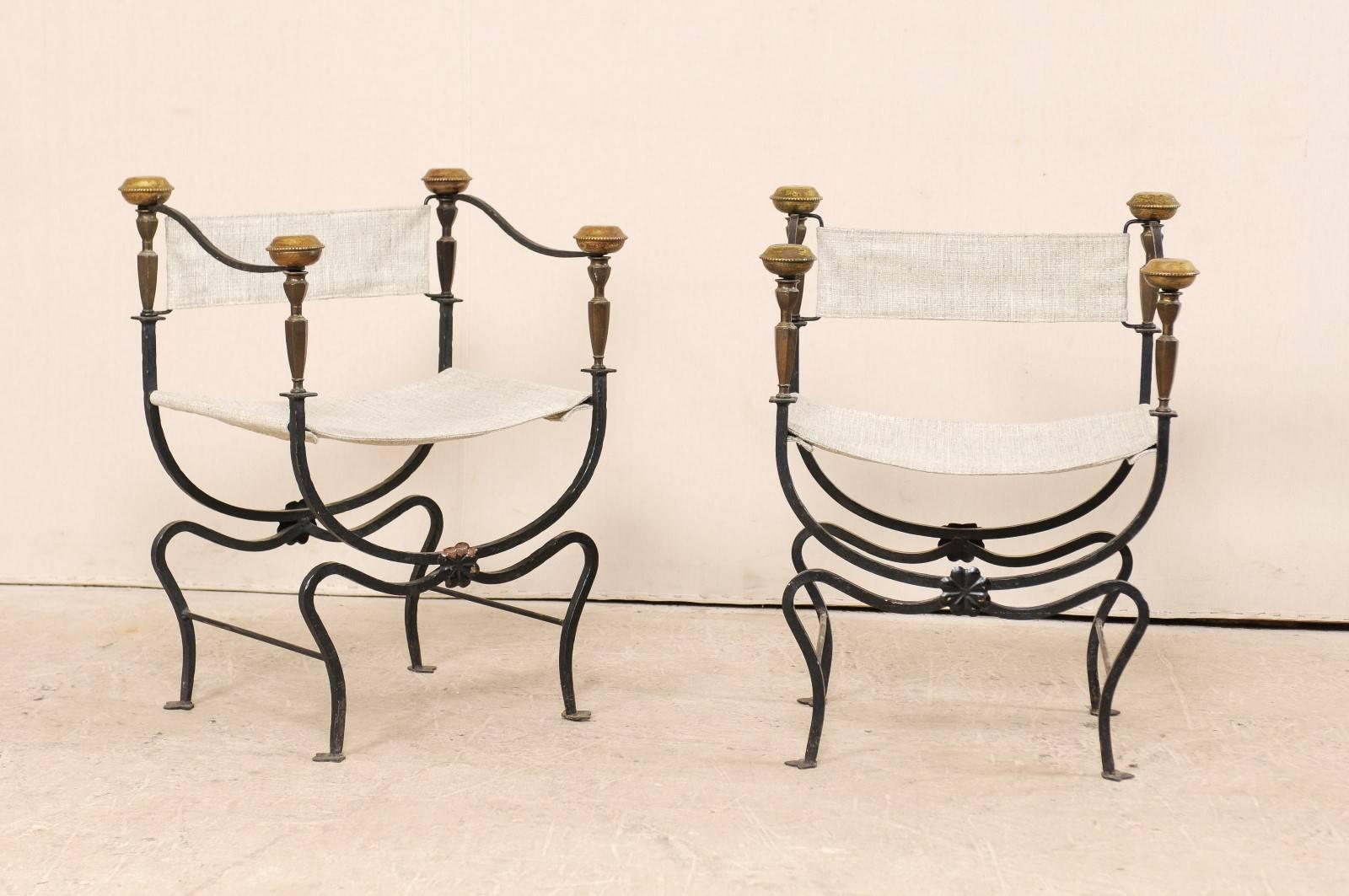 A pair of Italian curule savonarola chairs from the early 20th century. This pair of antique Italian curule chairs, also commonly called savonarola, are defined by their signature frames which connect where the upper frame meets the lower. There are