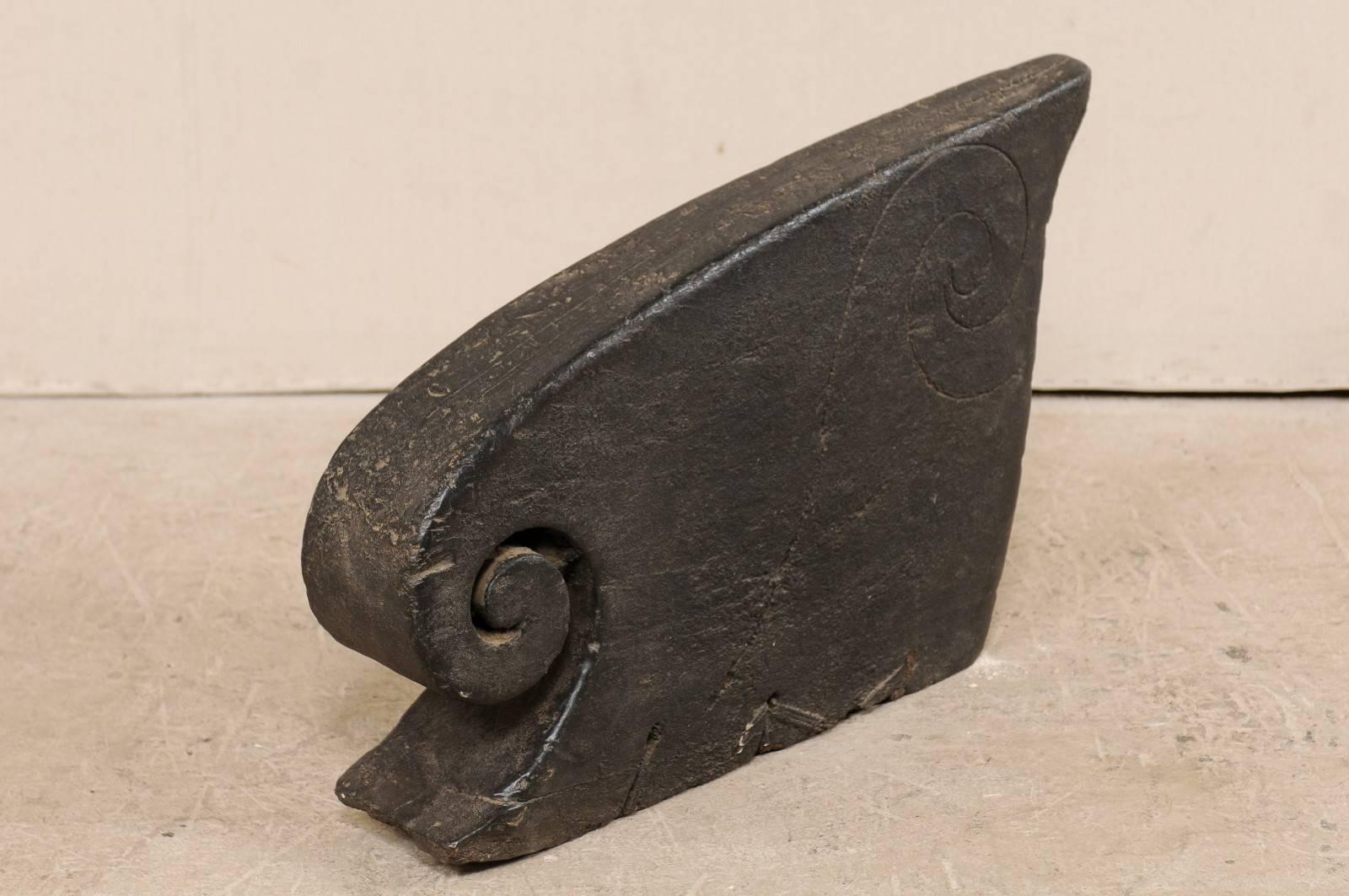 A South Indian (Kerala) wooden boat prow from the mid-20th century. This hand-carved boat prow from Kerala is adorn with curling volute and incised wave carvings at it's sides. These raised prows often decorated the boats of the Kerala, including