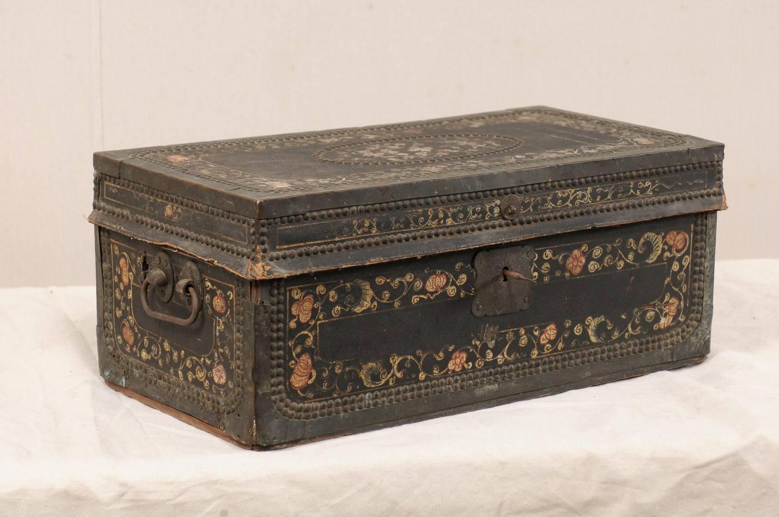 A 19th century Chinese camphor wood chest. This antique Chinese camphor wood trunk features a beautifully hand-painted flower motif on it's leather covered exterior, adorn with a decorative trimming of nail heads, and brass bound edges. The chest