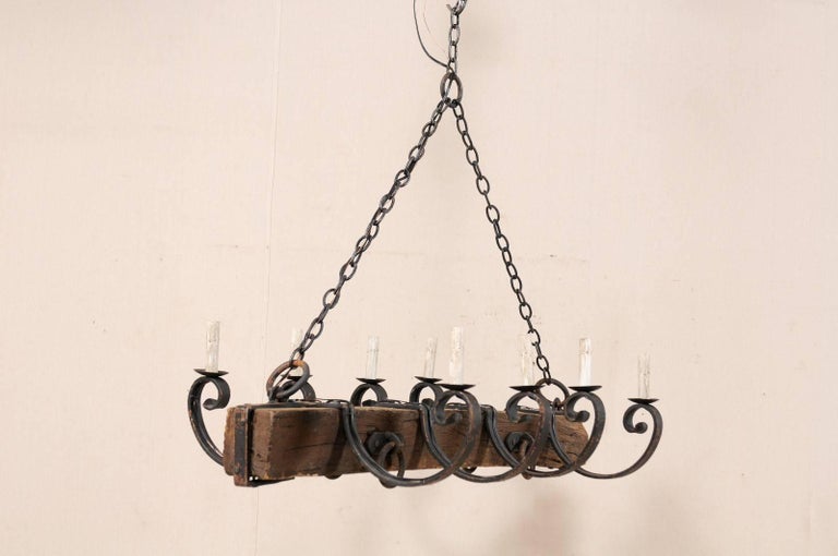 French Mid 20th Century Eight Light Rustic Wood And Scrolled Iron Carved French Mid 20th Century Eight Light Rustic Wood And Scrolled Iron Chandelier For