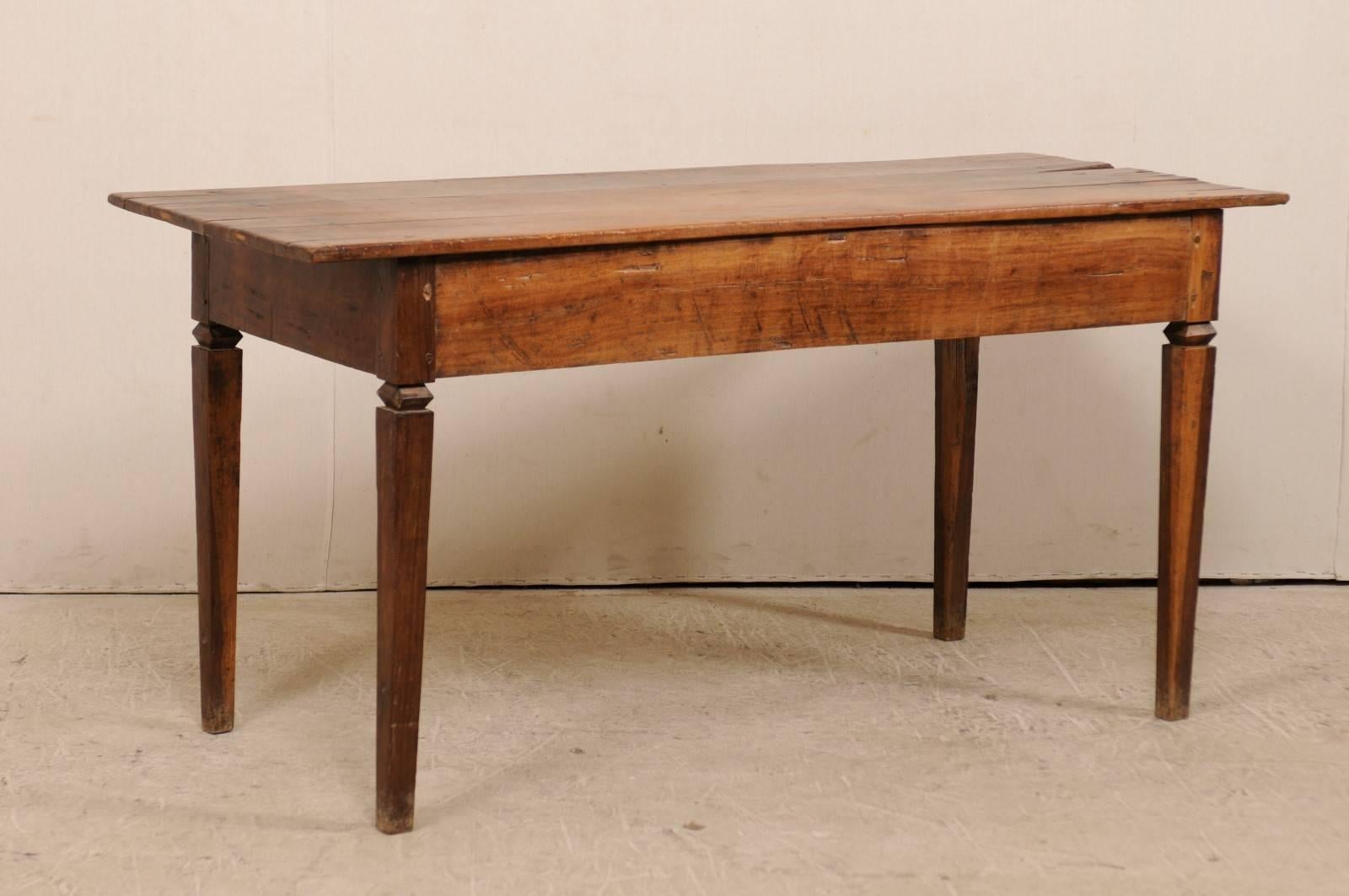 A Brazilian peroba wood table from the 19th century. This antique Brazilian has a rectangular-shaped top, straight skirt, and is raised upon profiled and tapered legs. The table is peroba wood (a tropical native hardwood, 35% harder than oak), and