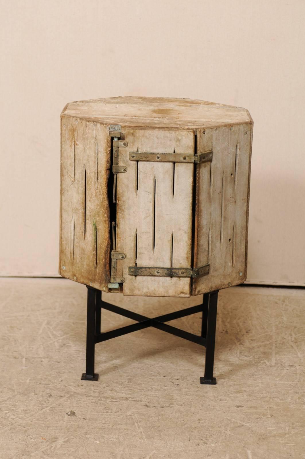 A Spanish box from early 20th century on black iron stand. This antique Spanish wood box has been re-purposed as whimsical little drinks or side table with the newer addition of a black iron base and legs. The wood box has an octagonal shape,