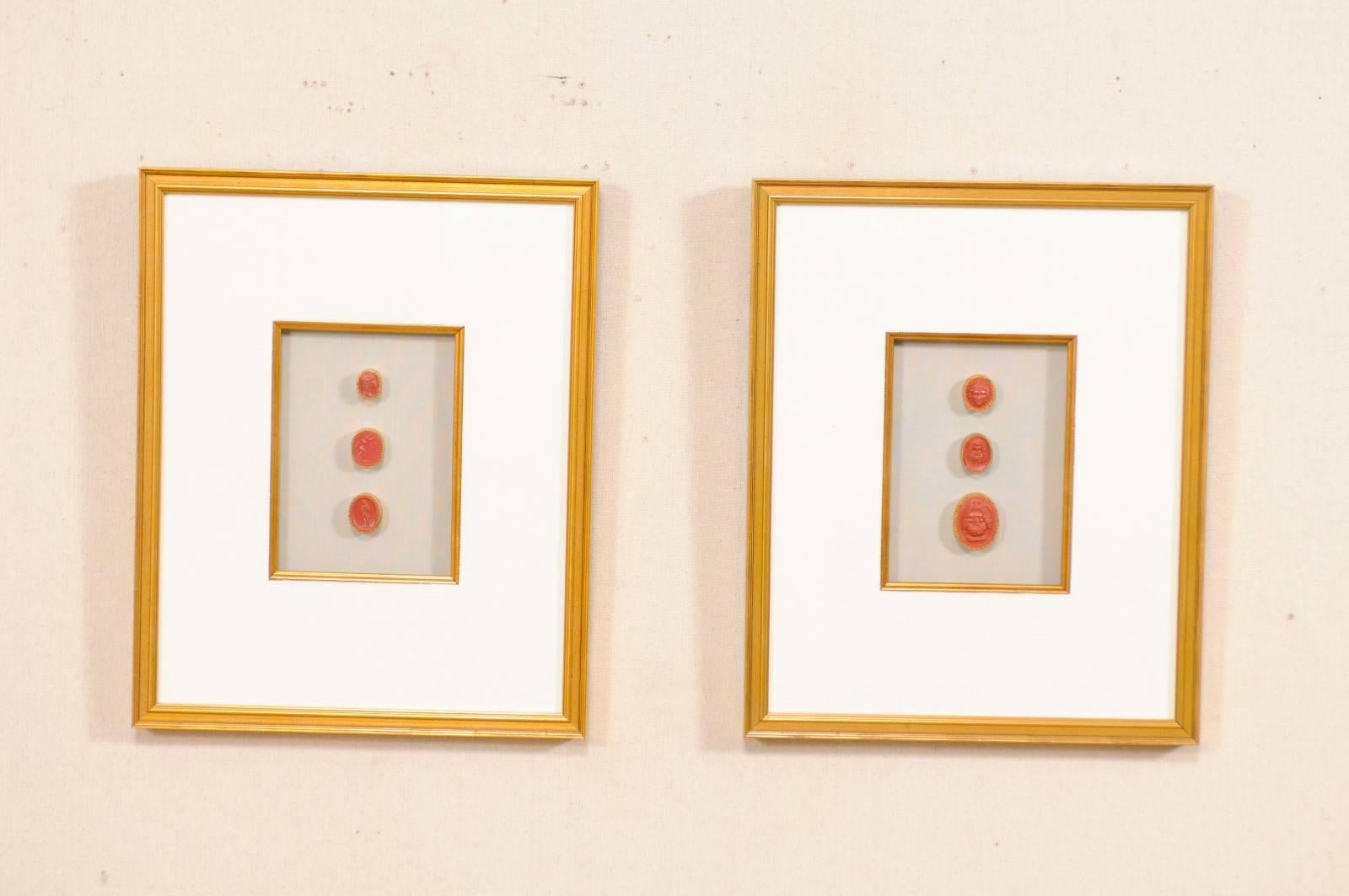 A pair of neoclassical Italian red intaglios from the early 20th century in custom frames. This set of red colored antique Italian intaglios (which were purchased by us in Sweden) have been set within a pair of custom wood framed shadow boxes with