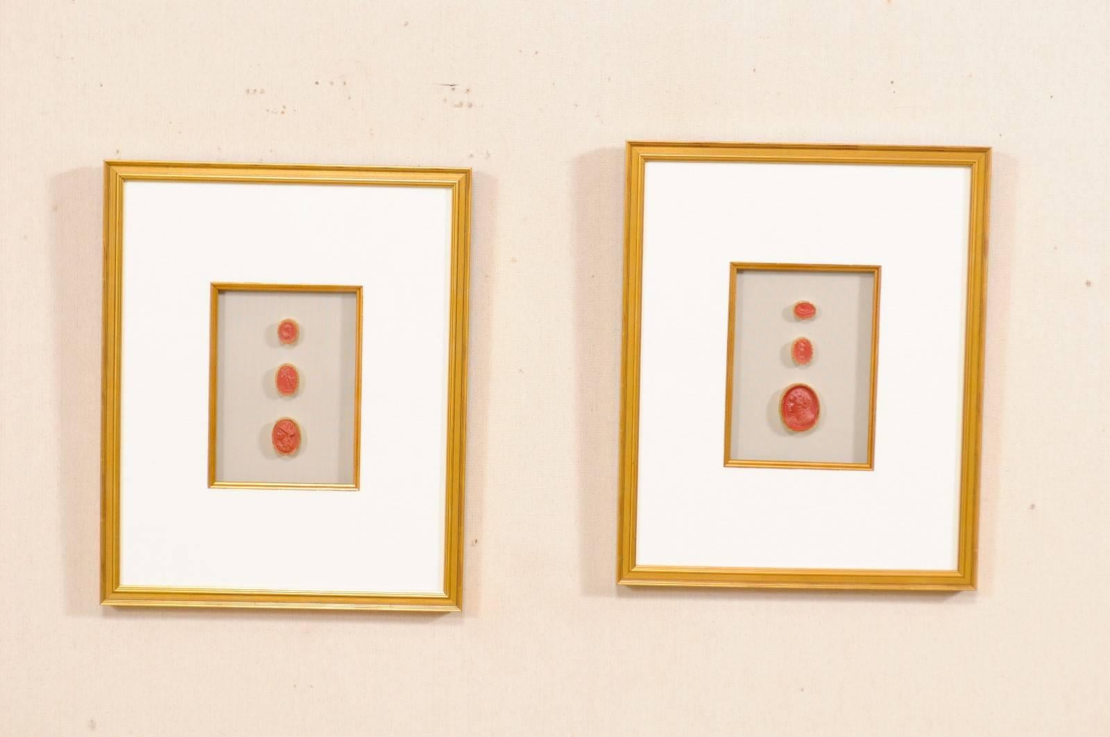 A pair of neoclassical Italian red intaglios from the early 20th century in custom frames. This set of red colored antique Italian intaglios (which were purchased by us in Sweden) have been set within a pair of custom wood framed shadow boxes with