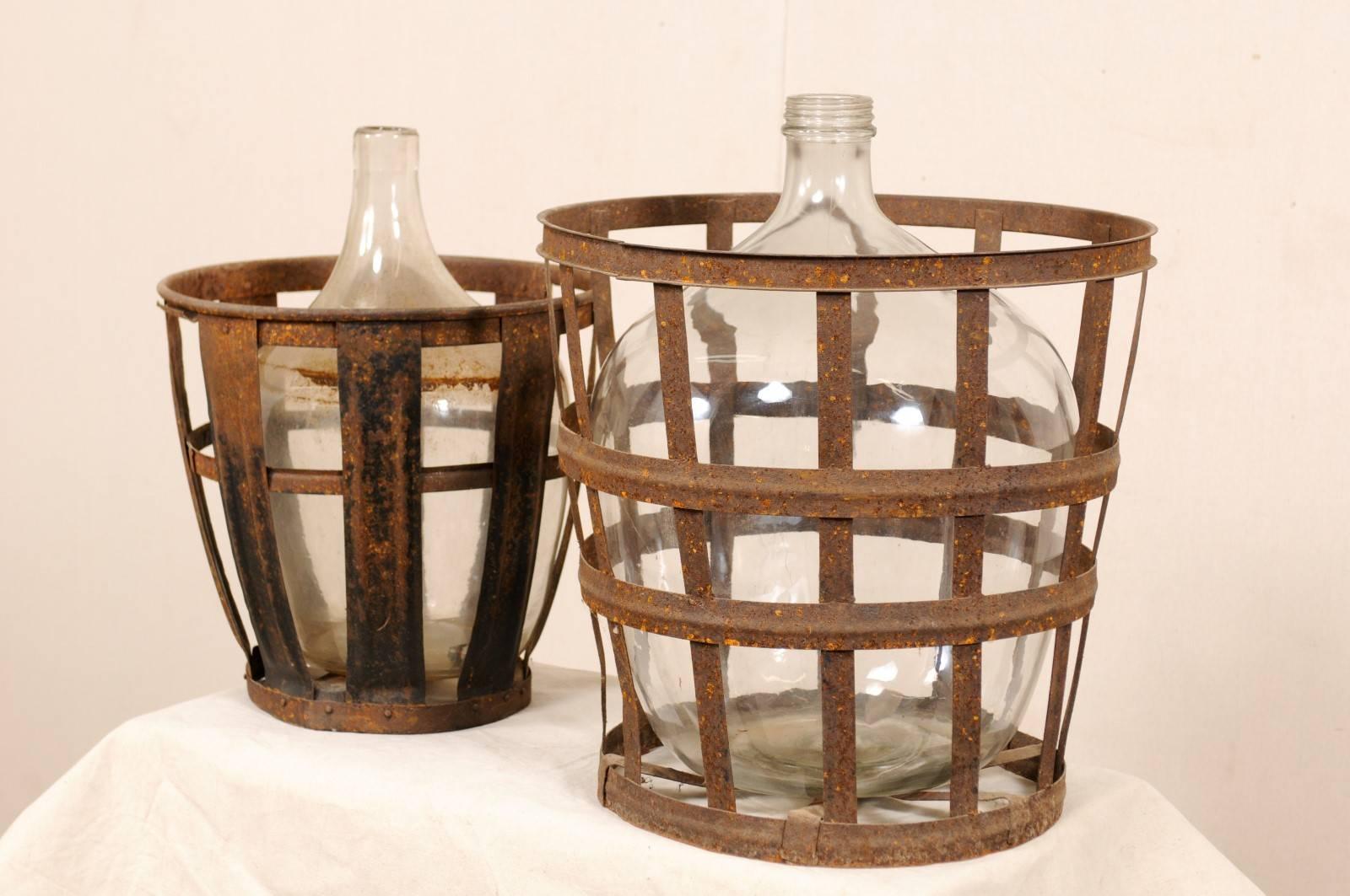 Rustic Pair of French Mid-20th Century Vintner Iron Baskets with Demijohn Wine Bottles
