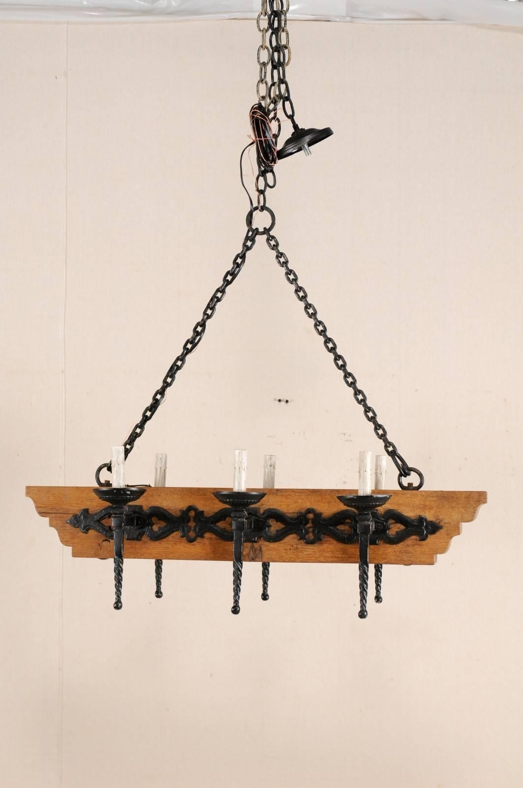 Carved French Vintage Six-Light Wood and Ornate Iron Chandelier with Torch Style Arms For Sale