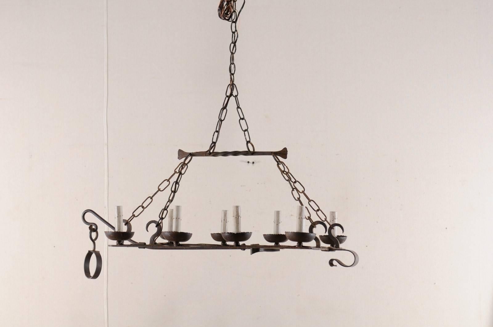 Rustic French Mid-20th Century Eight-Light Forged Iron Chandelier Made from a Spit-Jack