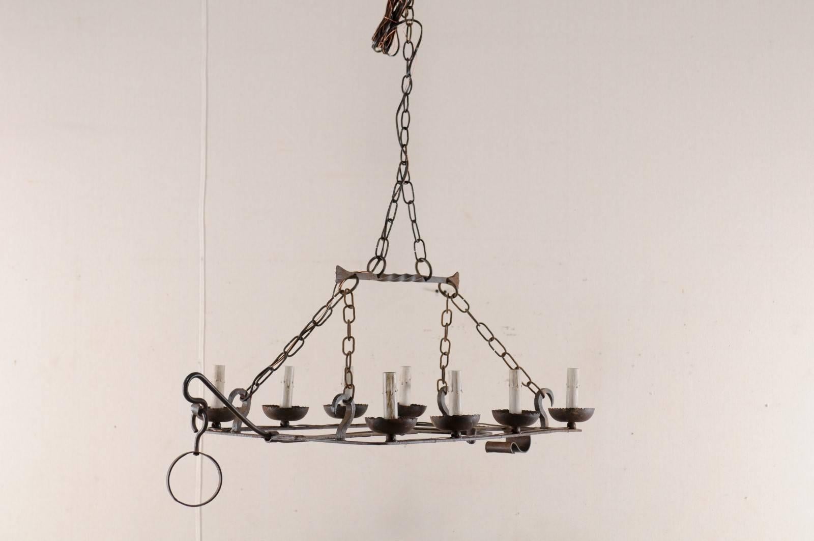 French Mid-20th Century Eight-Light Forged Iron Chandelier Made from a Spit-Jack In Good Condition In Atlanta, GA