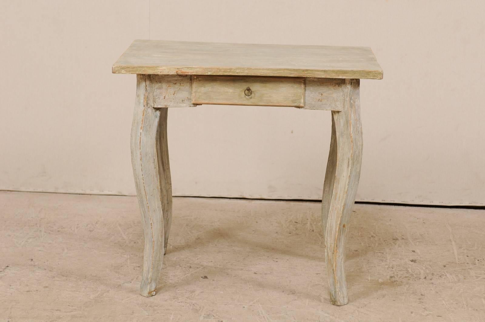 A late 19th century European painted wood side table. This antique table from Europe features a single-drawer with petite ring pull, a rectangular-shaped overhung top, and squared cabriole style legs. This table has washes of grey, blue, green and