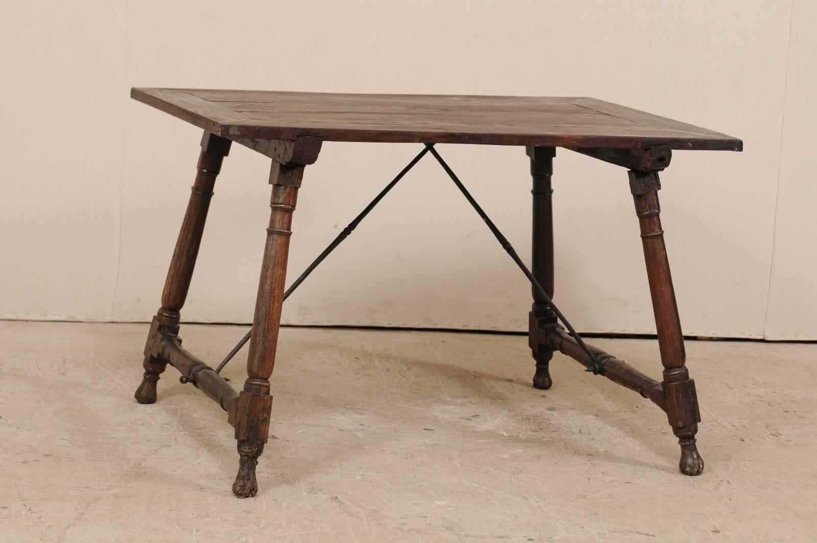 An antique Italian wood and iron stretchered desk table from the late 18th-early 19th century. This Italian desk features a rectangular-shaped top which is raised with outwardly tilting turned legs, which are supported with turned beams at each far