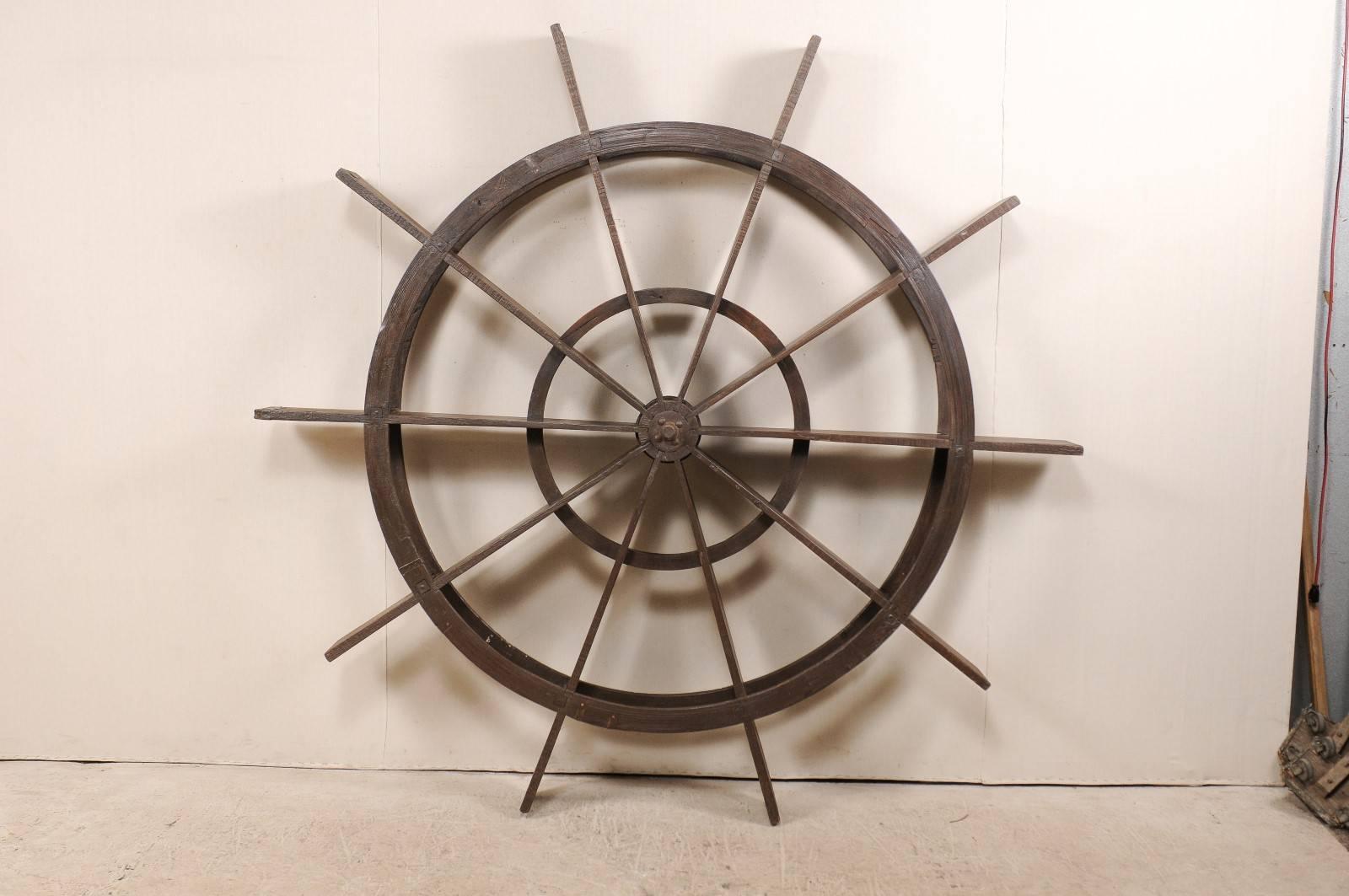 A large antique water wheel from Kerala, India. This Kerala water wheel which stands at more than 7 ft tall, also known as a 