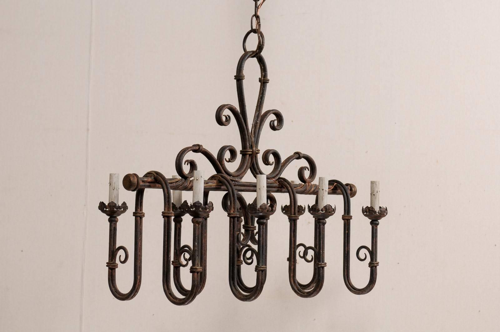 Patinated An Elaborate French Iron 8-Light Chandelier w/Deep Swag Arms & Fleur-De-Lis Top For Sale