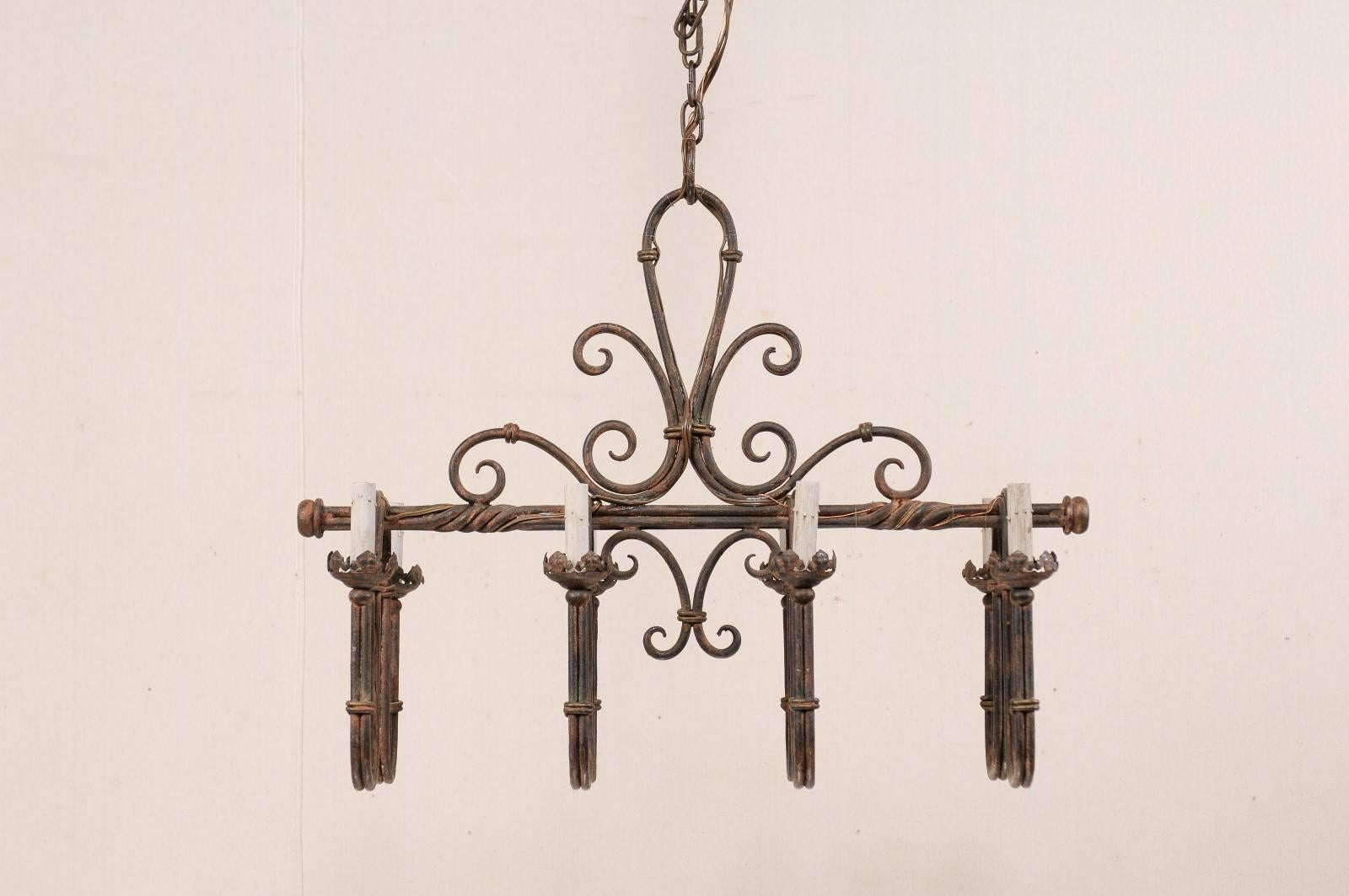 An Elaborate French Iron 8-Light Chandelier w/Deep Swag Arms & Fleur-De-Lis Top In Good Condition For Sale In Atlanta, GA
