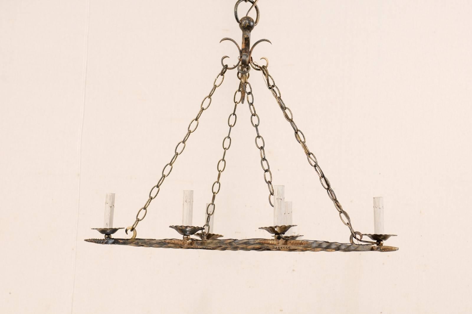 A French vintage six-light painted iron chandelier. This French mid-20th century iron chandelier has an overall rectangular shape comprised of two horizontally positioned parallel bars, crossed perpendicularly with three shorter bars. Each of the