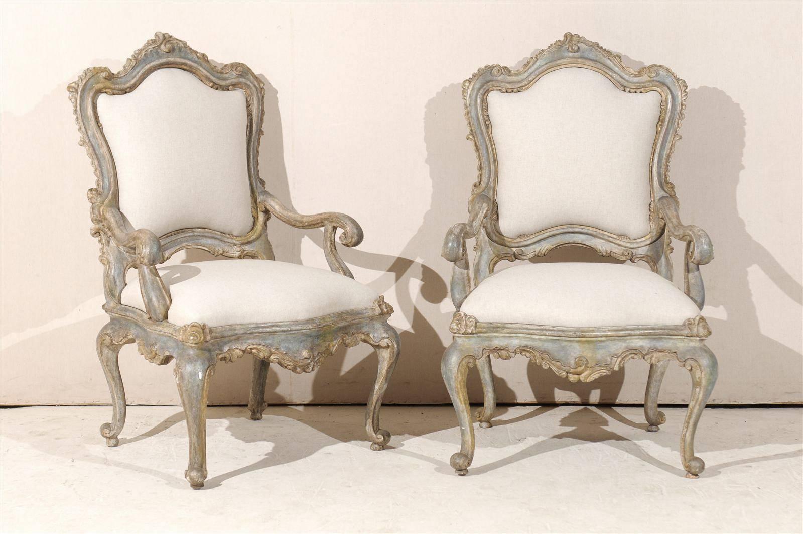 A pair of Italian Venetian style painted and gilded wooden armchairs with original paint from the mid-20th century (circa 1930-1960). Scrolled arms and cabriole legs, exquisite carving on the skirt and top rail of the armchairs.
Newly upholstered