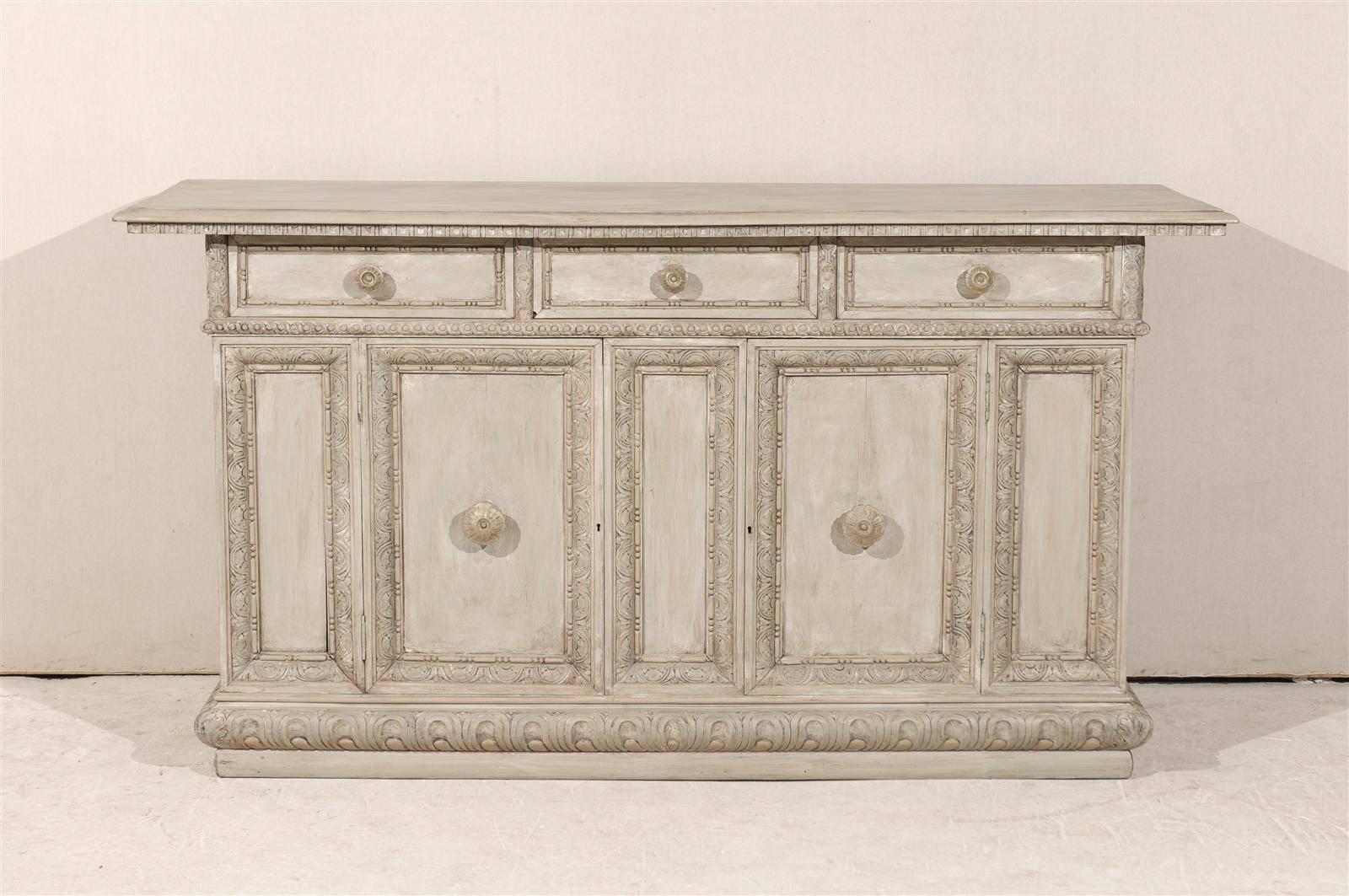 An Italian 19th century painted wood buffet / credenza with two doors, three drawers, beautifully carved details including guilloche frieze and dovetailed joints.