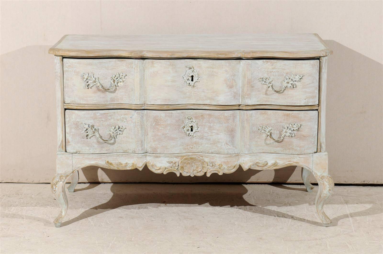 A Swedish 19th century painted wood two-drawer chest with short cabriole legs, nicely scalloped skirt with shell carving and Rococo style hardware.