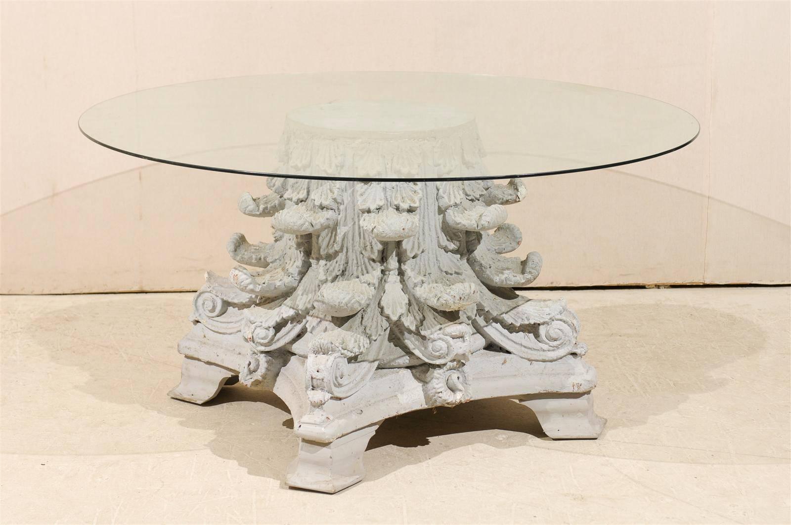 An American round table with carved Corinthian painted base and round glass top from the 20th century. The feet are a later addition. This Corinthian capital base is made of an old composite of concrete and horse hair.

 