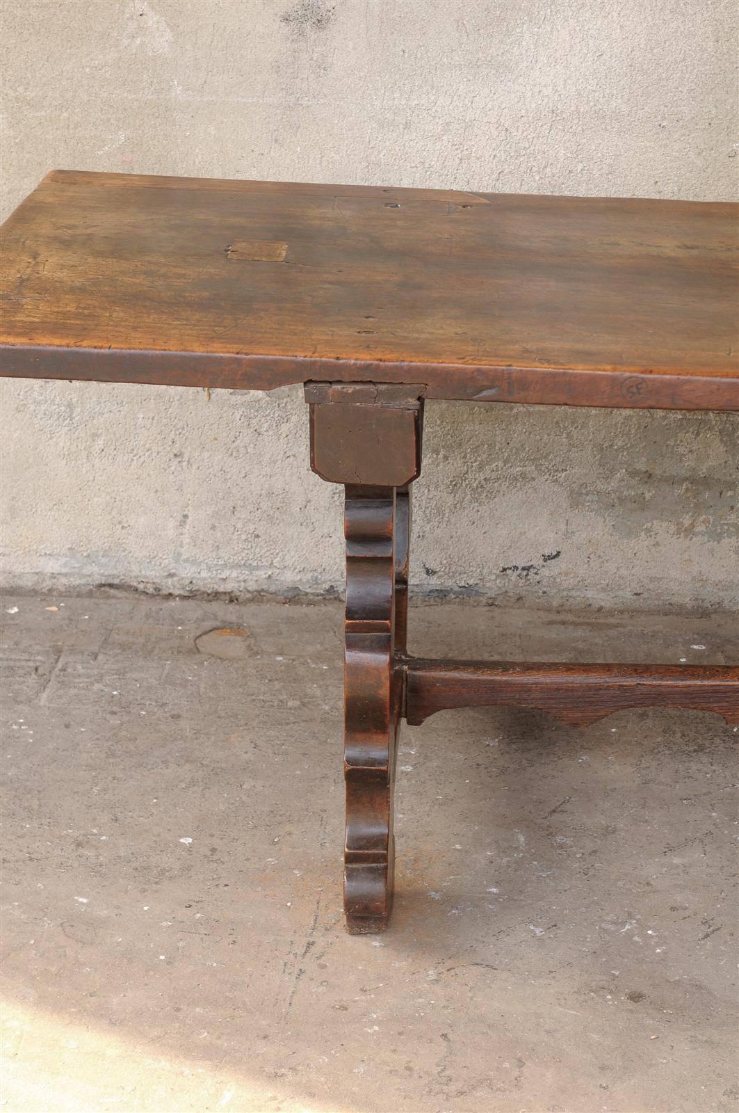 An 18th Century Italian Walnut Dining Table with Carved Trestle Legs & Cross Bar In Good Condition For Sale In Atlanta, GA
