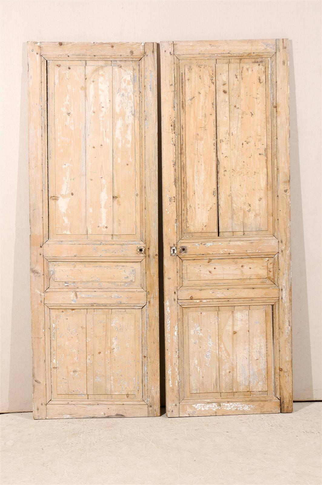 A pair of 19th century French scraped wooden doors with good distressed look.