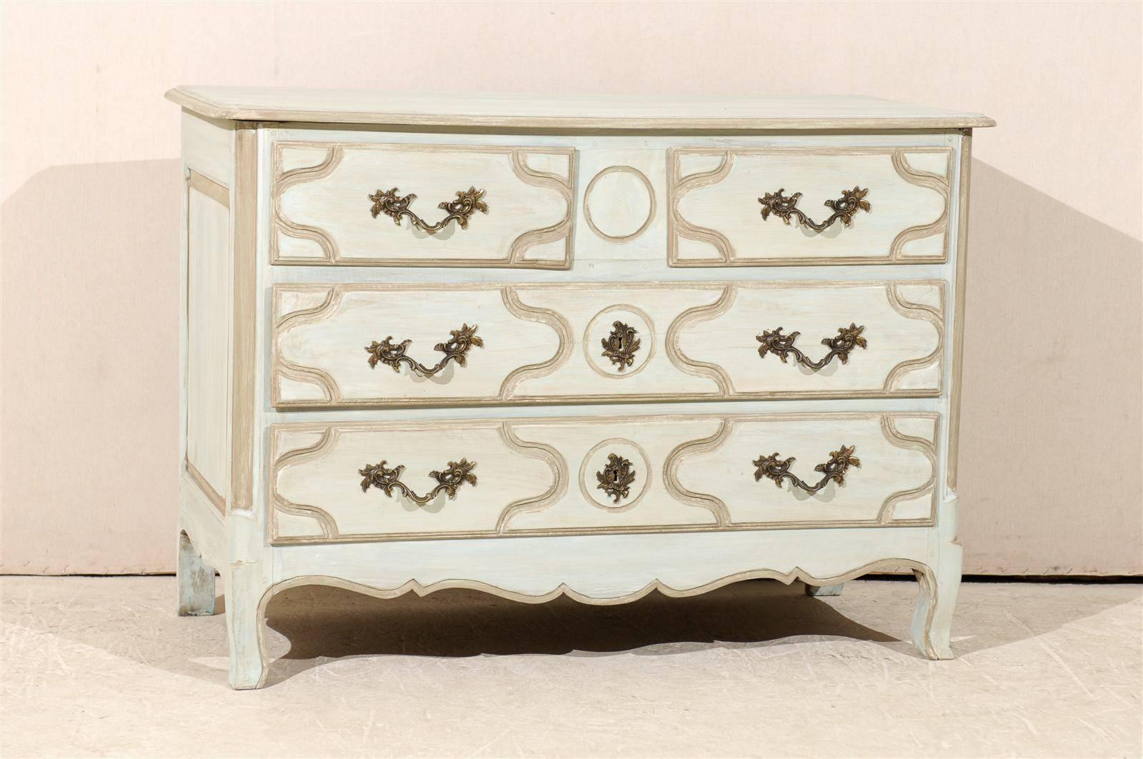 A French 1920s four-drawer painted wood chest with patterned drawers and scalloped skirt. This French four-drawer chest sits on cute cabriole feet. This piece is painted a light color with some darker neutral grey accents throughout. This French