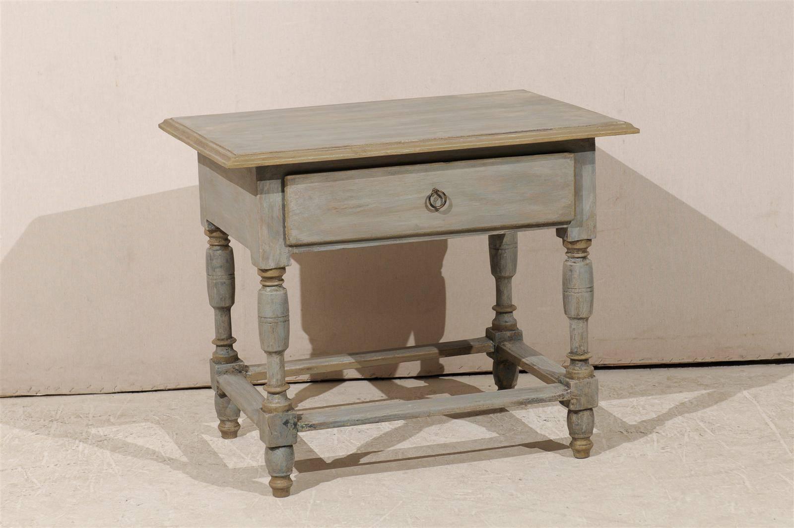 A Swedish early 19th century painted wood one-drawer bedside table with light turned legs on plain side stretcher. Later top.