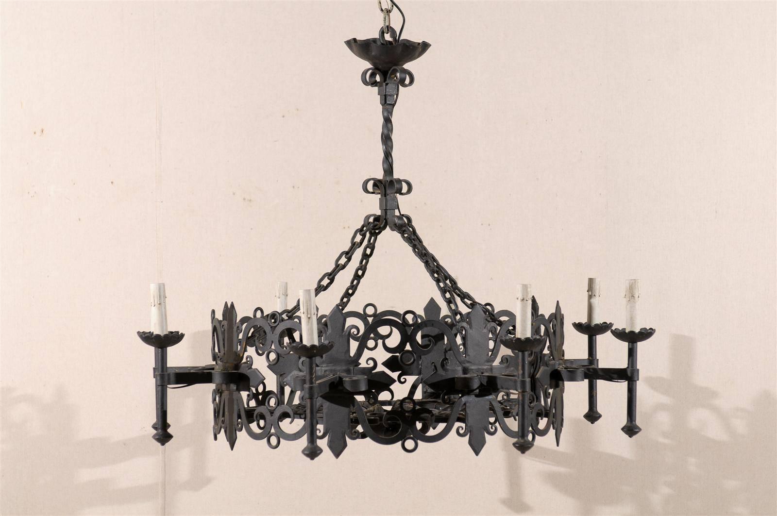 An Italian wrought iron eight-light round chandelier from the mid-20th century.

This iron chandelier has been rewired for the US and comes with a complimentary 3 foot chain and canopy painted to match.
 