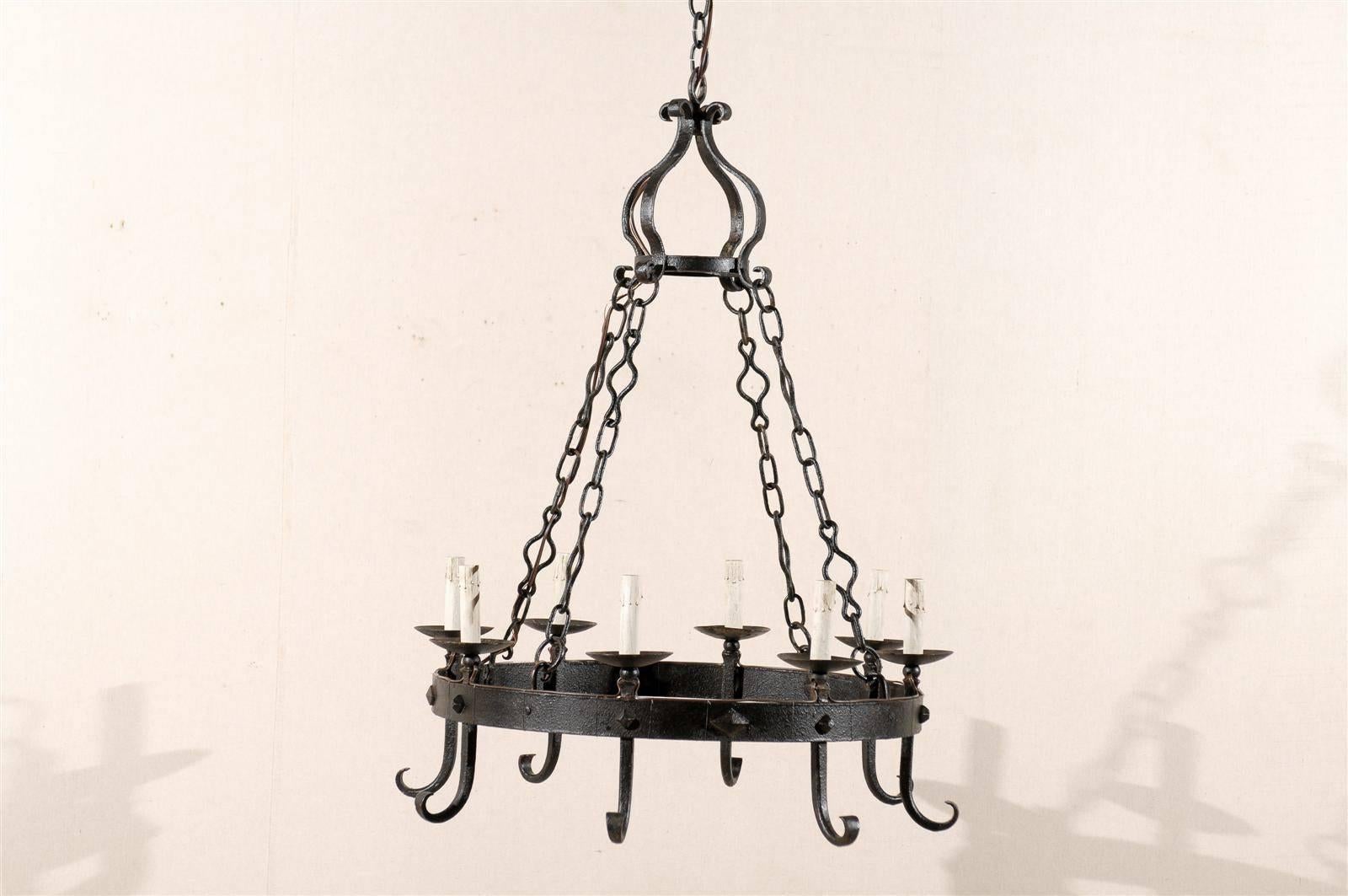 A French wrought iron eight-light chandelier with circular ring from the mid-20th century.

This iron chandelier has been rewired for the US and comes with a complimentary 3 foot chain and canopy painted to match.

  