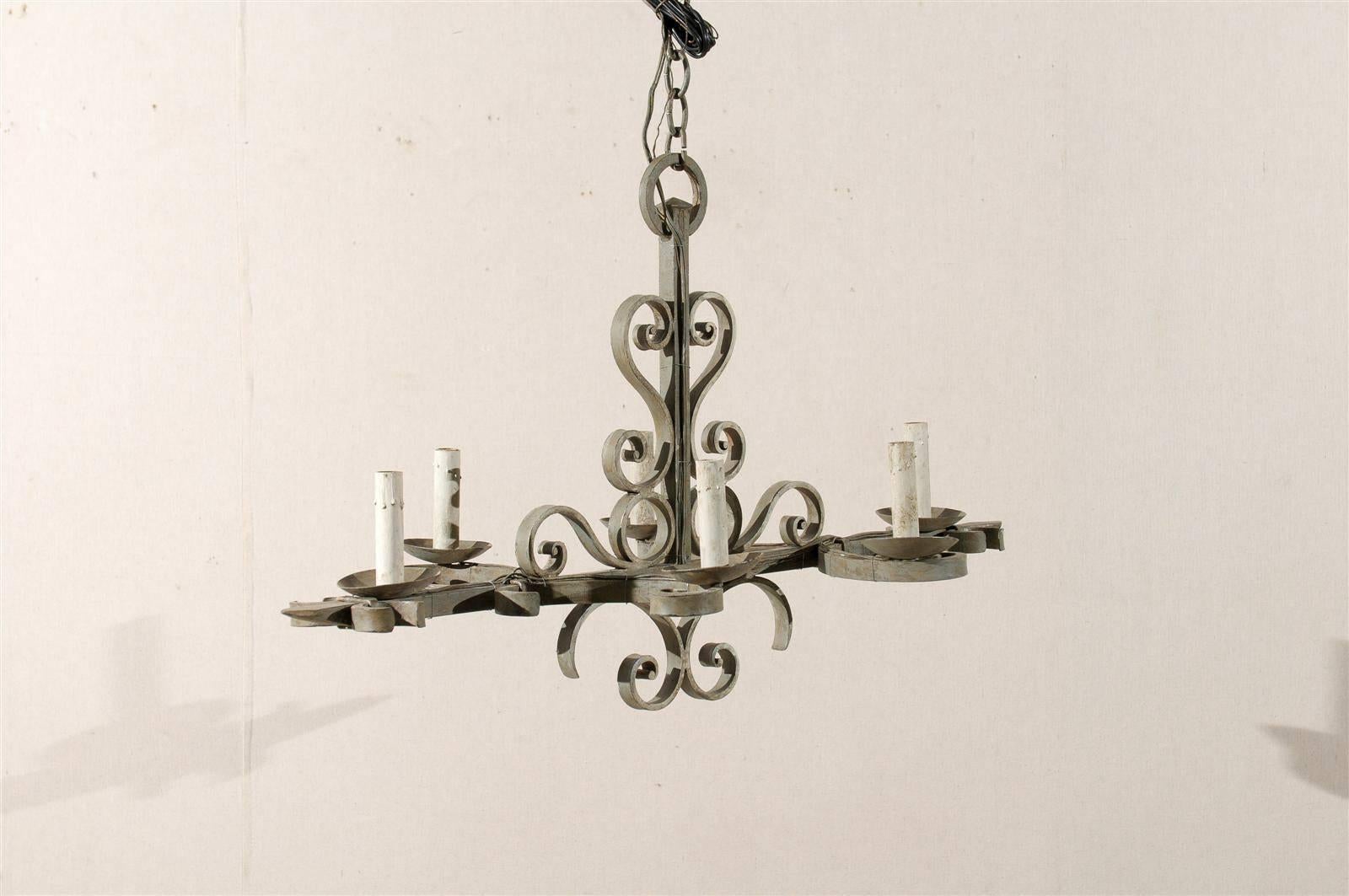 A French mid-20th century six-light painted iron chandelier with s-scroll motif attached to the Central Part and cup shaped bobeches.

This French painted iron chandelier has been rewired for the US and comes with a complimentary 3 foot chain and