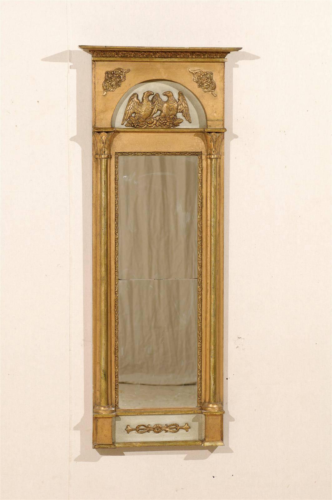 A Swedish 19th century gilded and painted slender wooden mirror with imperial eagles on floral ornaments and Thin Half-Columns with simple capitals on each side.
  